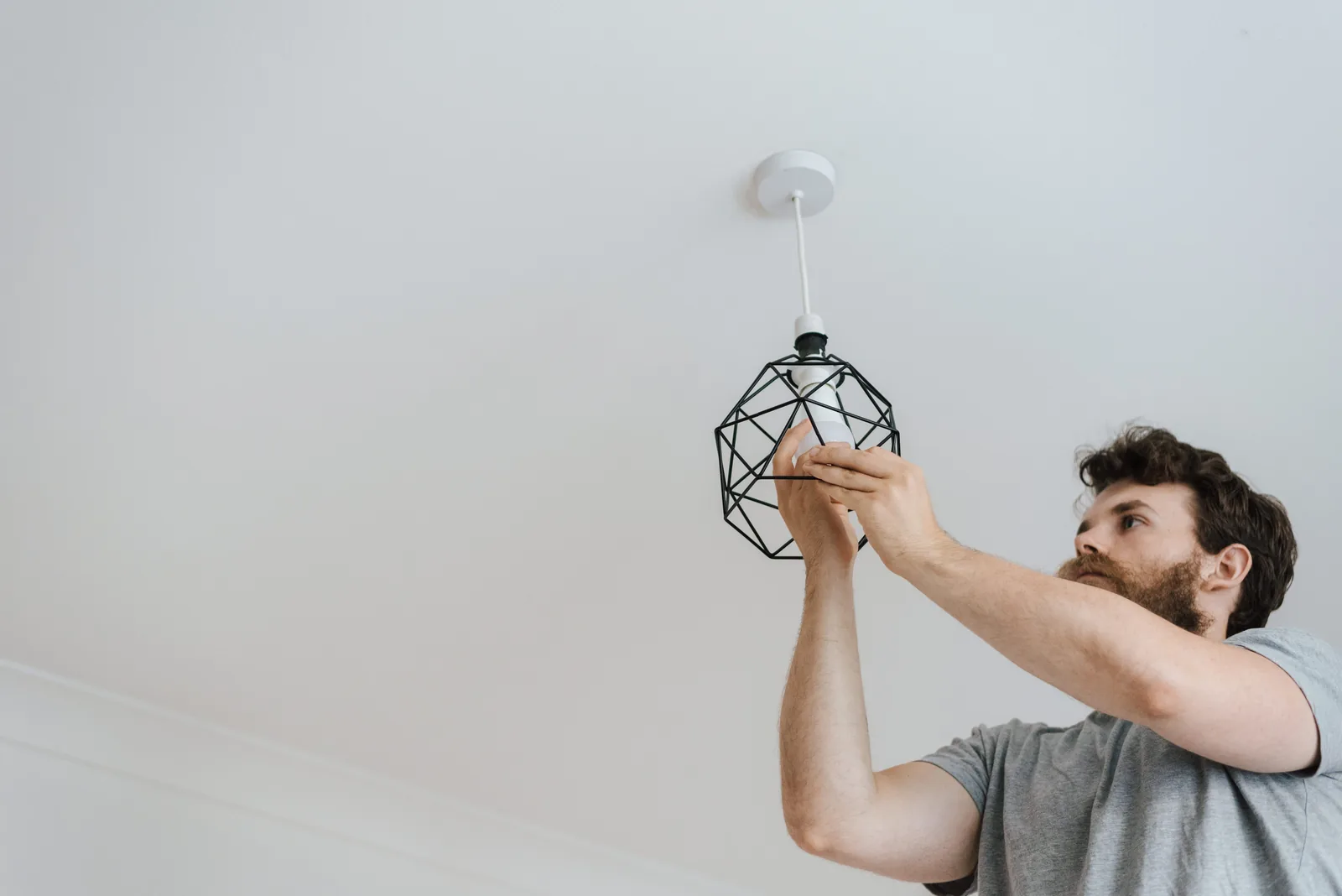 Fitting a lamp into a pendant fixture, for ev charger installation in Hamilton
